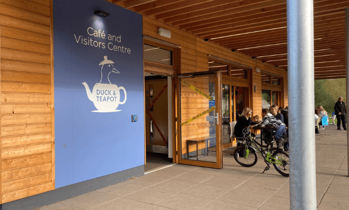 Needham Lakes Cafe and Visitors Centre, The Duck and Teapot. Photo of the entrance with door open and bikes parked.