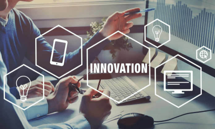 Person at desk with the word Innovation inside a shape
