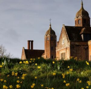 Long Melford hall, surrounded by daffodils.